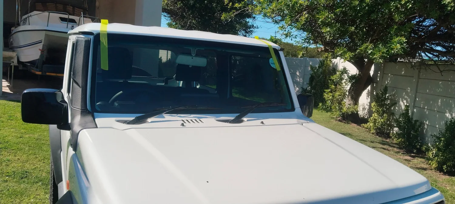 White vehicle with its windscreen visible during a glass job